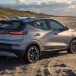 A silver 2022 Chevy Bolt EUV is facing away on a beach.