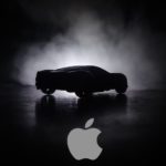 A car silhouette is on a black background with the Apple logo.