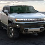 A silver 2021 GMC Hummer EV is shown from the front parked on sand, after leaving a GMC dealer near you.