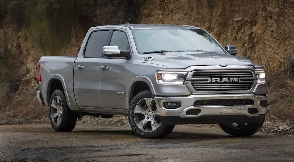 A gray 2019 used Ram Laramie is parked in front of a hill.