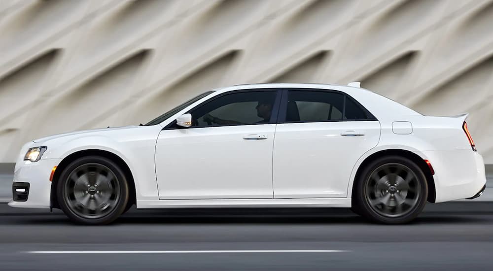 A white 2019 used Chrysler 300 is shown from the side in front of an off-white textured wall.