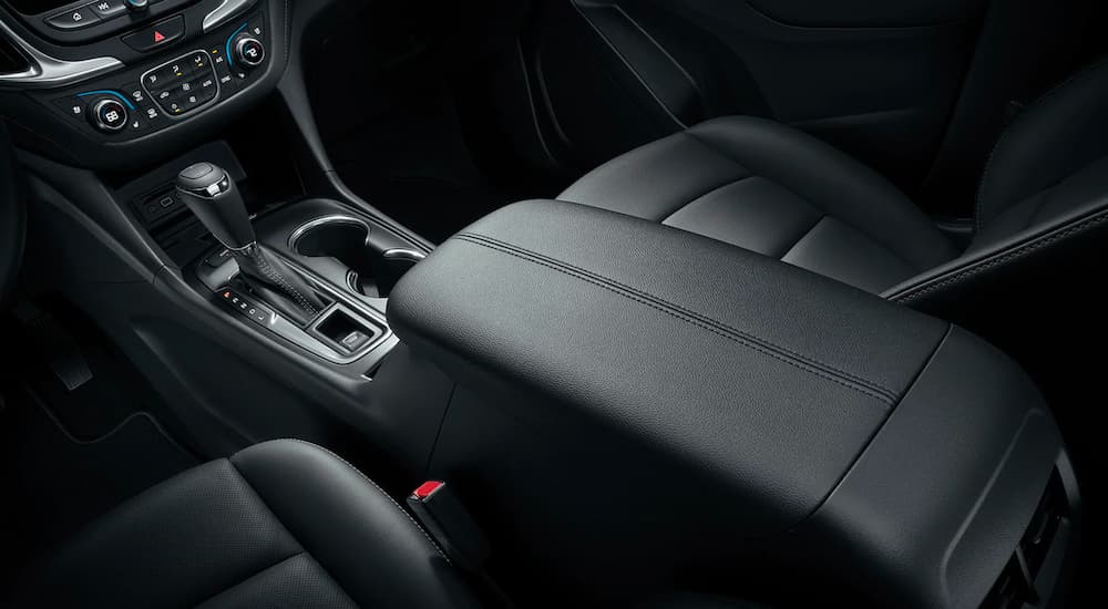 The black center console and seats are shown in a 2021 Chevy Equinox.