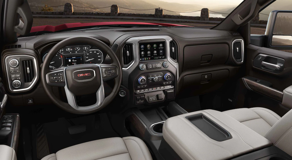 The interior of a 2021 GMC Sierra 3500 shows the steering wheel and infotainment screen.