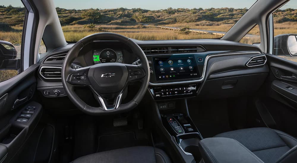 The interior of a Chevy Bolt EV shows the steering wheel and infotainment screen. 