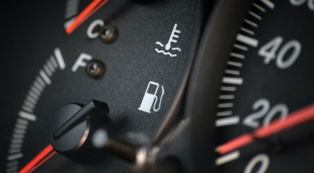 A close up shows the gas gauge on an instrument cluster.