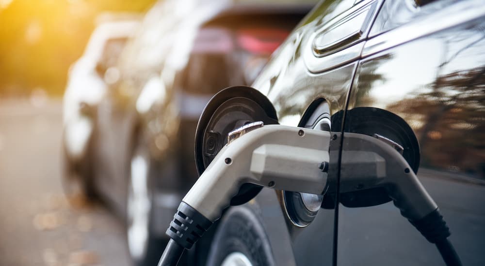 An Electric car is charging after leaving the electric car dealership