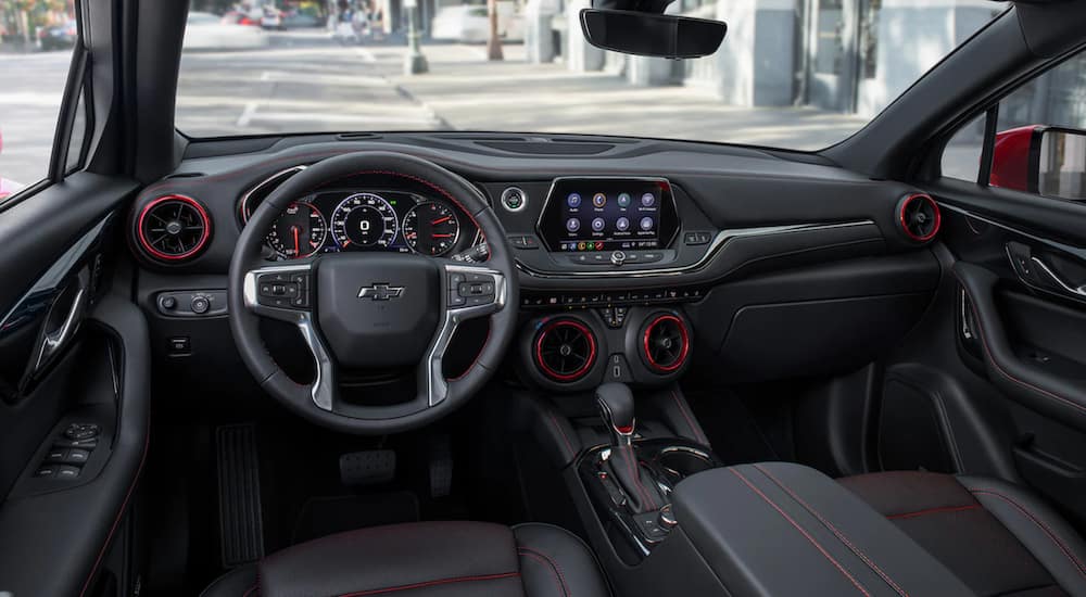 The interior of a 2021 Chevy Blazer shows the steering wheel and infotainment screen. 