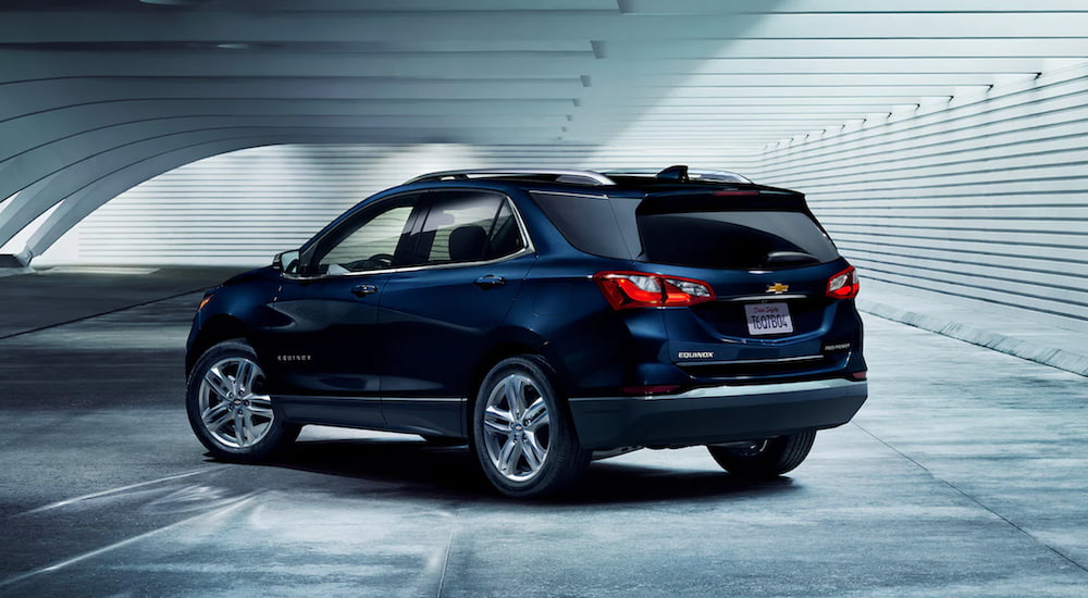 A blue 2021 Chevy Equinox is parked in a warehouse.