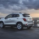 A silver 2021 Chevy Trax is parked on a jetty at sunset after after participating in a 2021 Chevy Trax vs 2021 Chevy Trailblazer comparison.