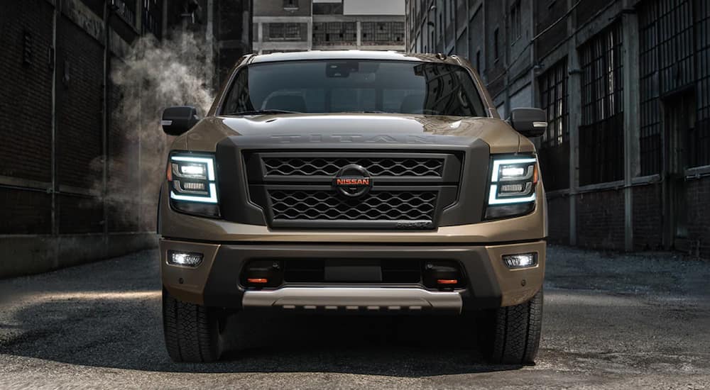 A tan 2021 Nissan Titan XD is parked in an alleyway.