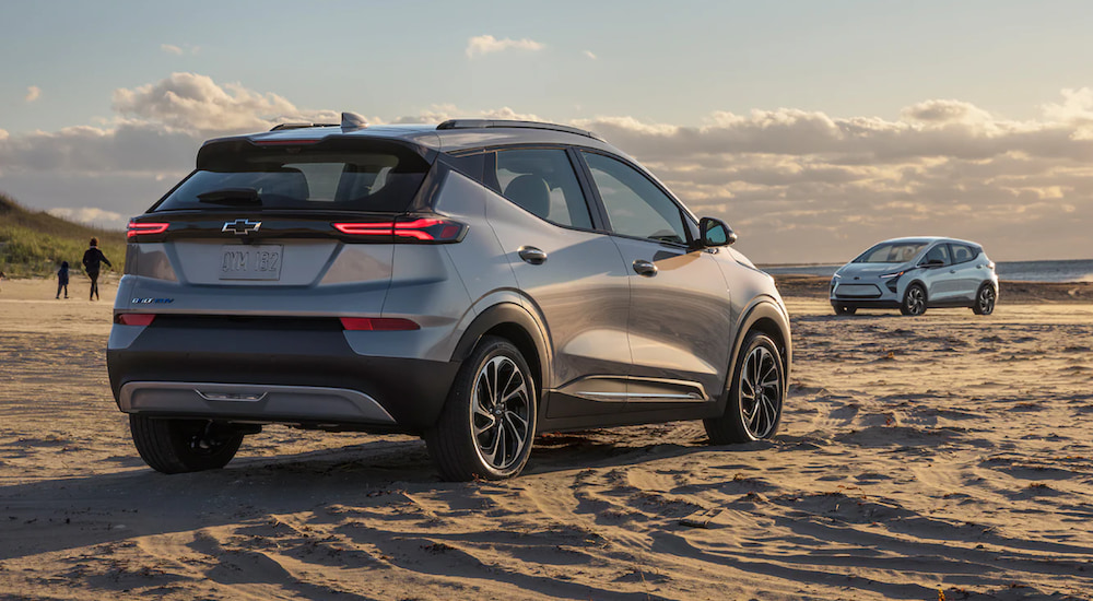 A silver 2022 Chevy Bolt EUV is parked on the beach after leaving a Chevy Dealer near you.