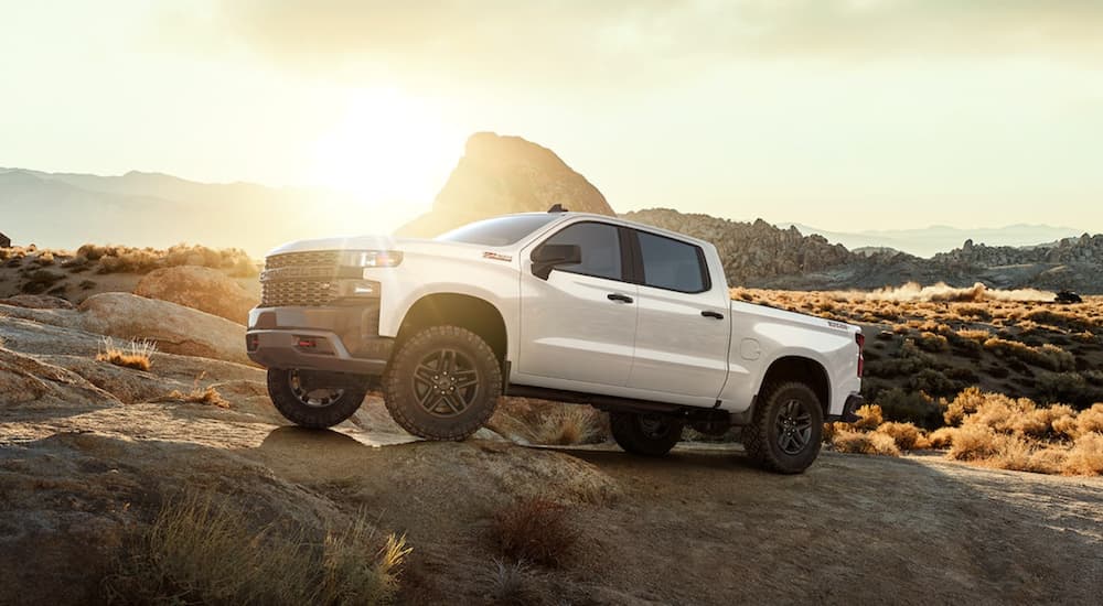 A white 2021 Chevy Silverado 1500 is parked in a desert.