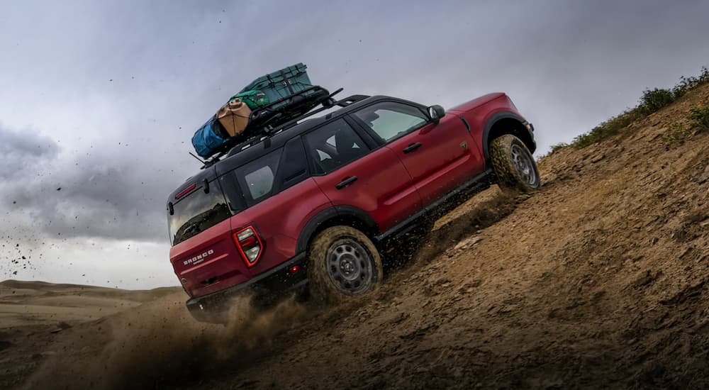 A red 2021 Ford Bronco Sport drives in the desert after leaving the Ford Bronco Sport Dealership