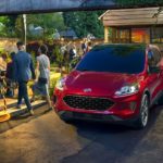A red 2021 Ford Escape is parked in a modern garden.
