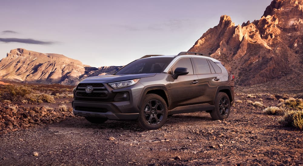 A grey 2021 Toyota RAV4 is parked in the mountains after leaving the Toyota RAV4 Dealer.