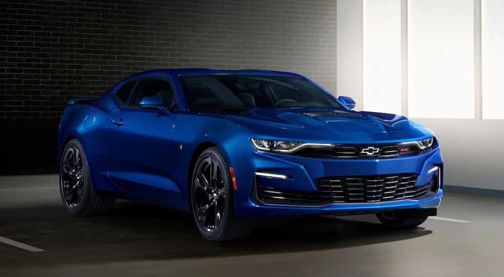 A blue 2021 Chevy Camaro is parked in a garage after leaving a used Chevy dealer.