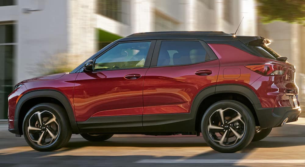 A red 2021 Chevy Trailblazer is driving through a city.