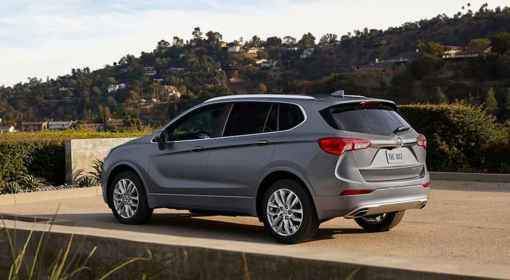 A grey 2020 Buick Envision is shown from an angle parked in a driveway.