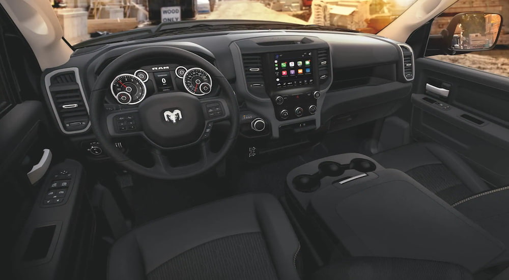 The interior of a 2020 Ram 3500 shows the steering wheel and infotainment screen.