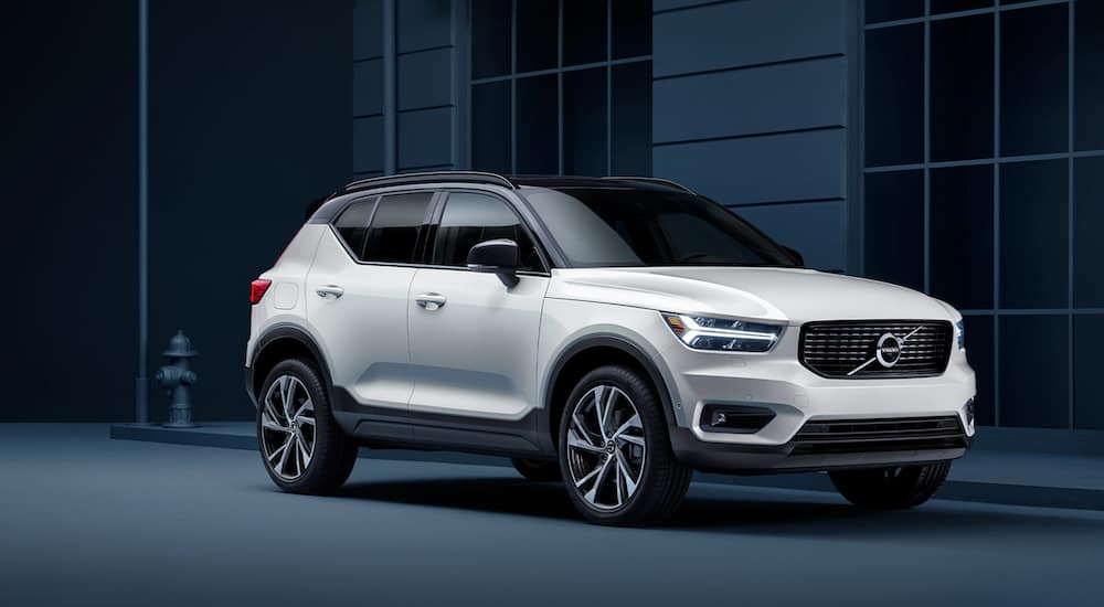 A white 2021 Volvo XC40 is parked outside of a modern building.