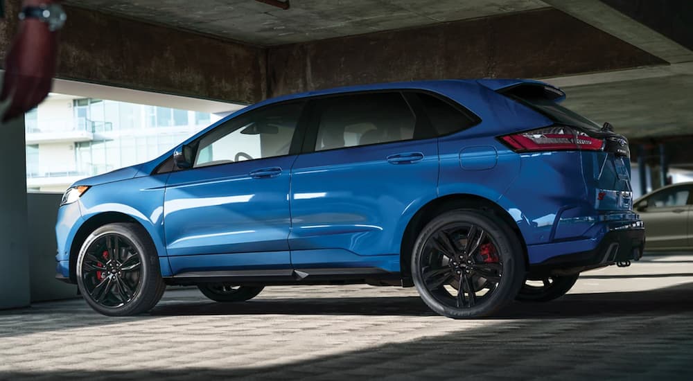 A blue 2021 Ford Edge is parked in a parking garage.