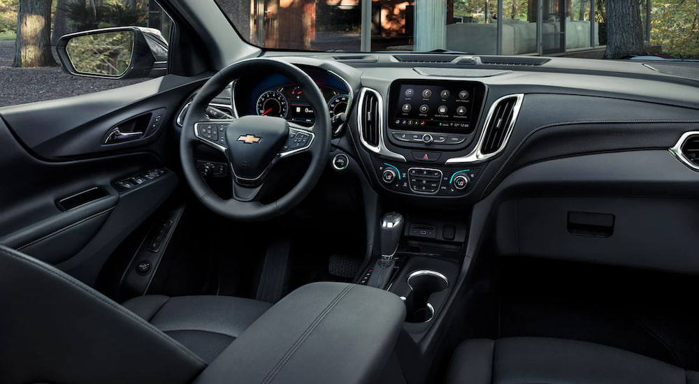 The interior of a 2021 Chevy Equinox shows the steering wheel and information screen.