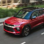 A red 2021 Chevy Trailblazer RS is driving through a city.