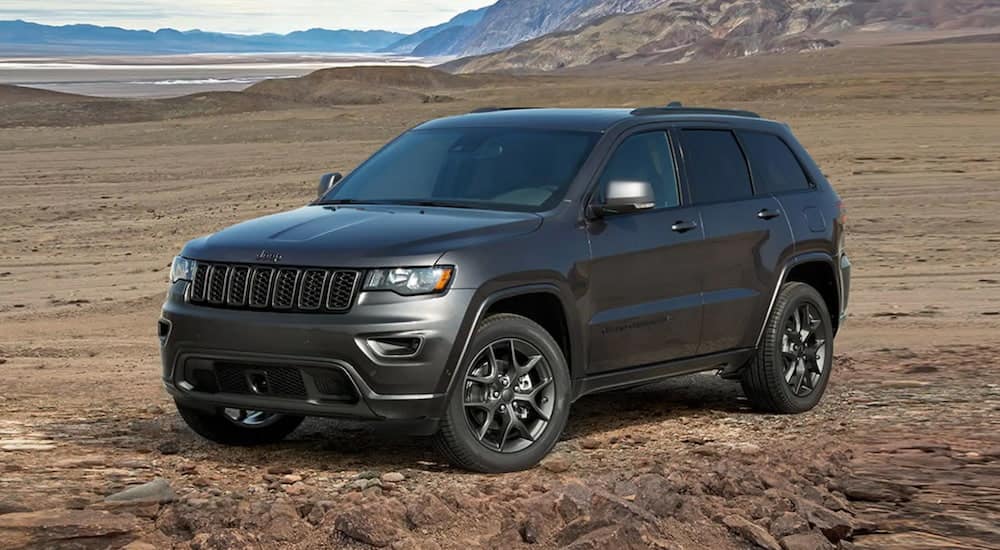 A 2021 Jeep Grand Cherokee is parked in a field after winning a 2021 Jeep Grand Cherokee vs 2021 Toyota 4Runner comparison.