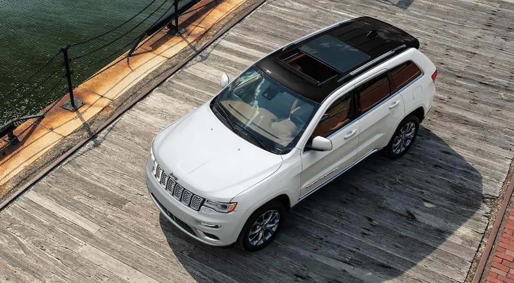 A white 2021 Jeep Grand Cherokee is parked on a jetty.