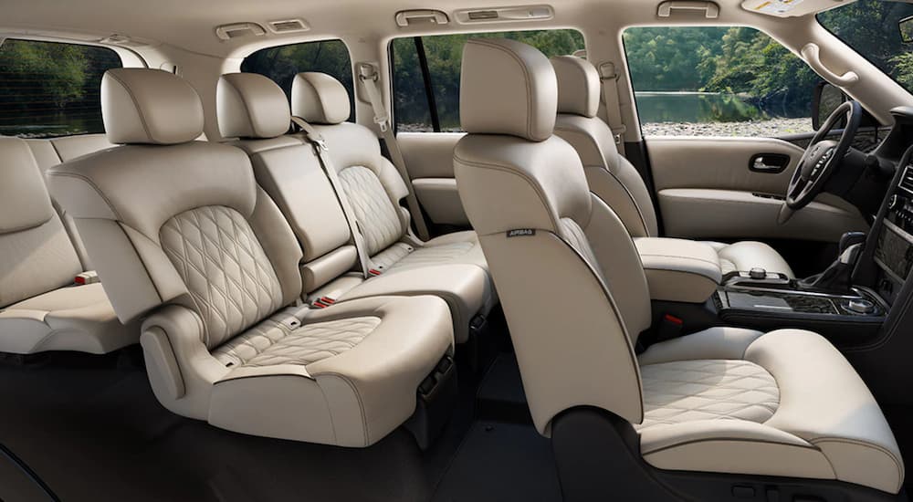 The tan interior of a 2021 Nissan Armada shows three rows of seating.