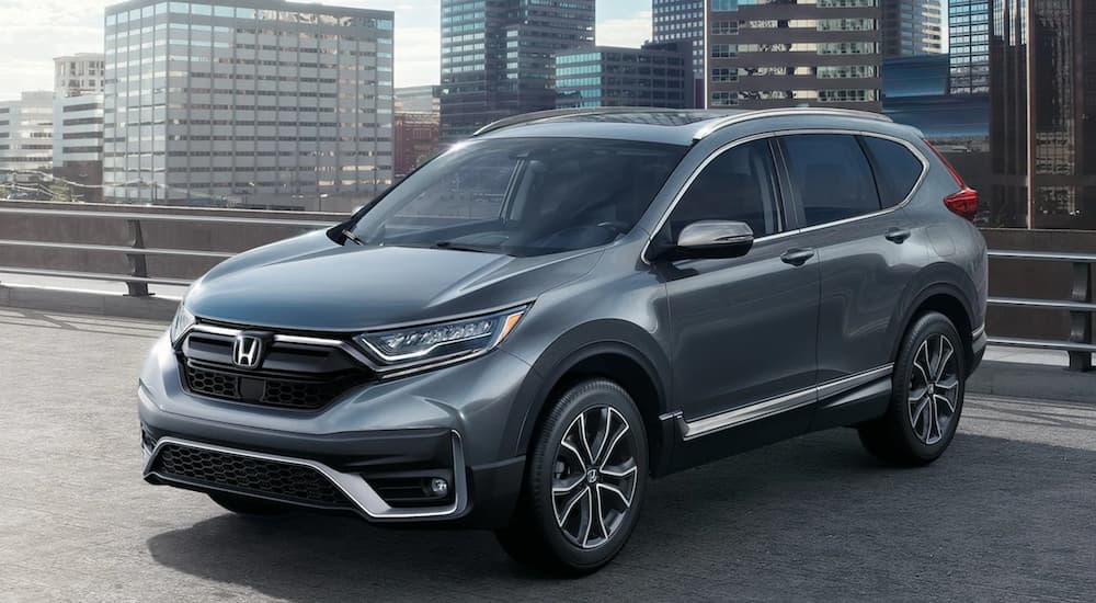 A silver 2021 Honda CR-V is parked on a city roof after leaving a Honda dealer. 