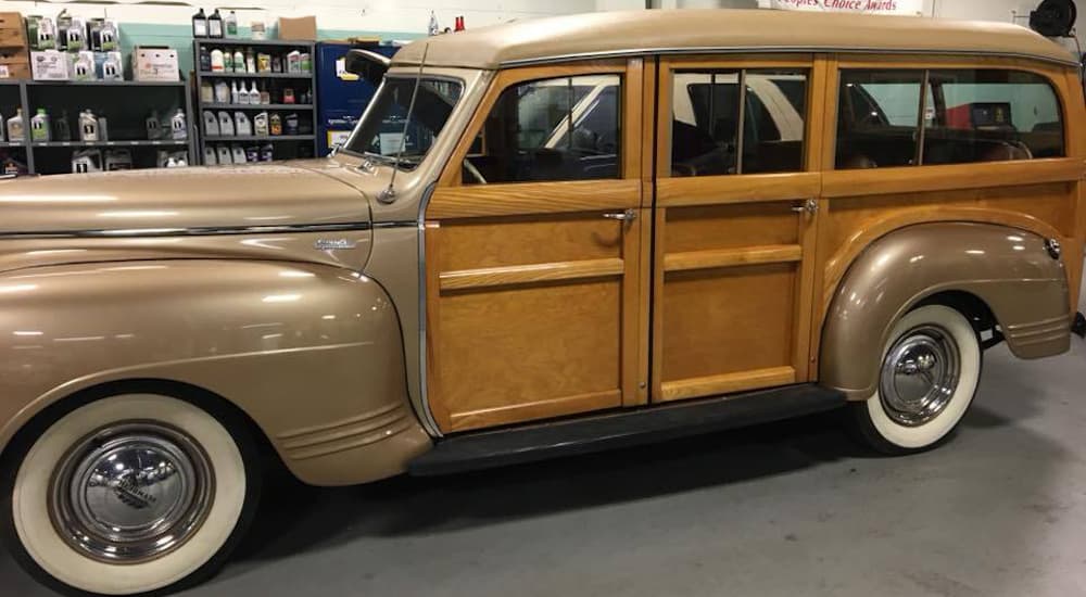 A wood panel 1940 Desoto is shown from the side.