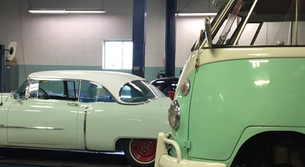 A green 1967 Volkswagen Bus is shown in a show with no wheel.