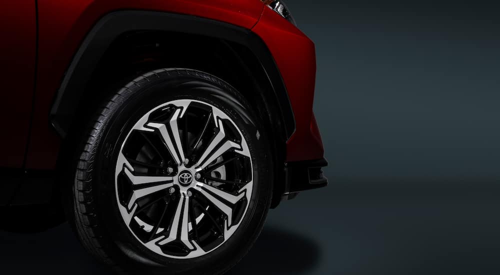The wheel of a red 2021 Toyota RAV4 Prime is shown.