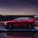 A red 2021 Toyota RAV4 Prime is parked in a modern compound.