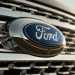 A 2021 Ford Expedition shows a close up of a Ford Emblem on the grille after leaving a used Ford dealership.