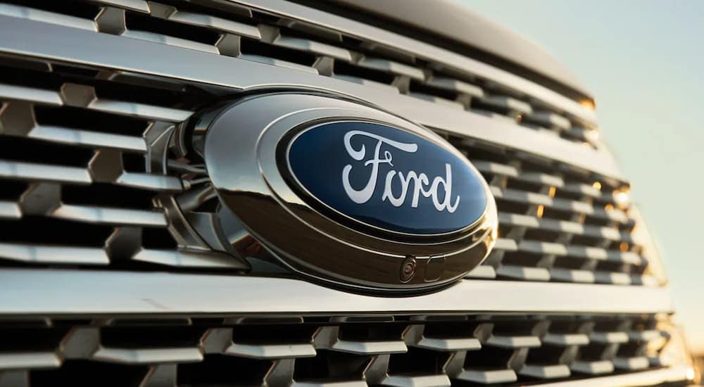 A 2021 Ford Expedition shows a close up of a Ford Emblem on the grille after leaving a used Ford dealership.