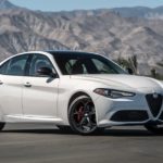 A white 2020 Alfa Romeo Giulia is shown parked on a racetrack.