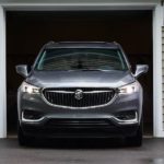 A grey 2021 Buick Enclave is shown from the front pulling out of a garage.