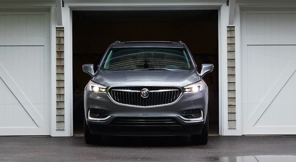 A grey 2021 Buick Enclave is shown from the front pulling out of a garage.