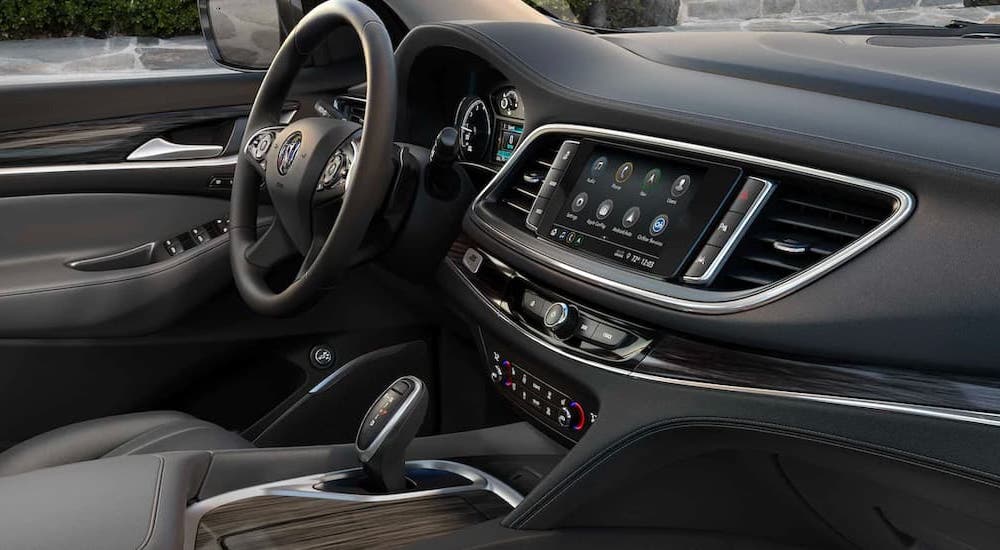 The black interior and infotainment screen are shown in a 2021 Buick Enclave.