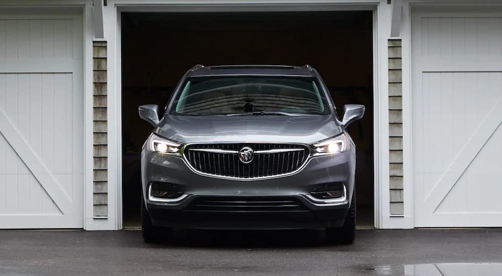 A silver 2021 Buick Enclave is parked in a garage.