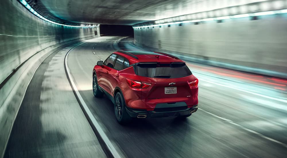 A red 2021 Chevy Blazer RS is shown from the back driving in a tunnel.