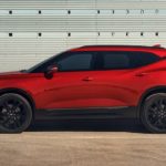 A red 2021 Chevy Blazer is shown from the side parked in front of a white wall after winning a 2021 Chevy Blazer vs 2021 Honda Passport comparison.