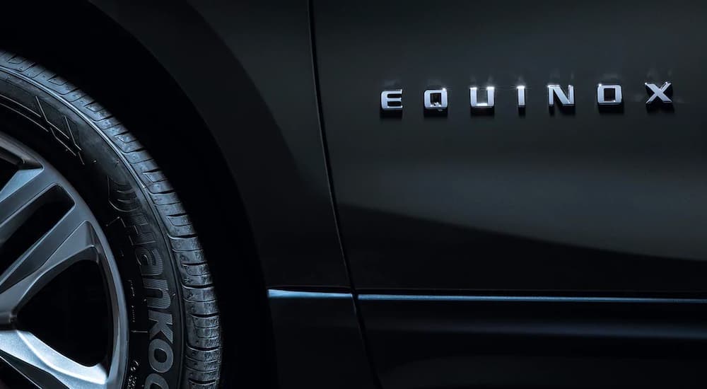 A close up shows the door badging on a black 2021 Chevy Equinox.
