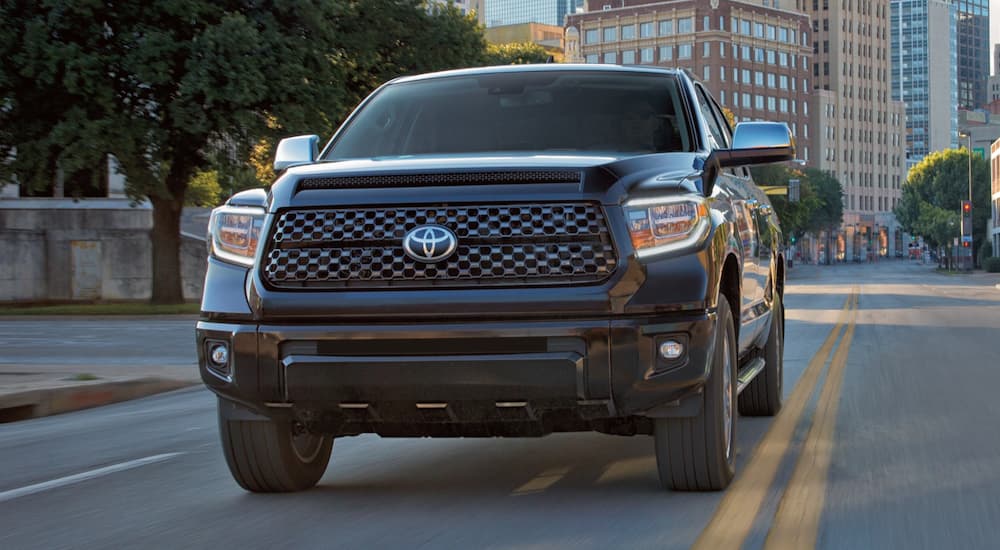 A black 2021 Toyota Tundra is shown driving from the front.