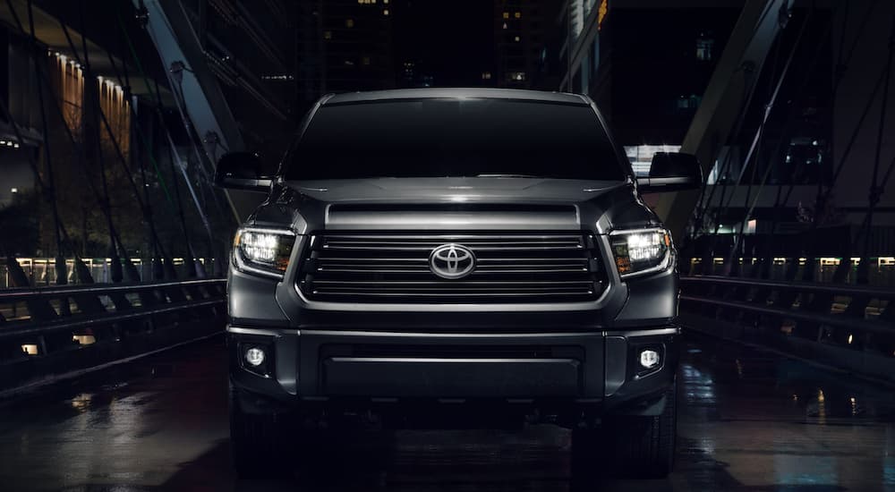 A grey 2021 Toyota Tundra is shown from the front parked at night.