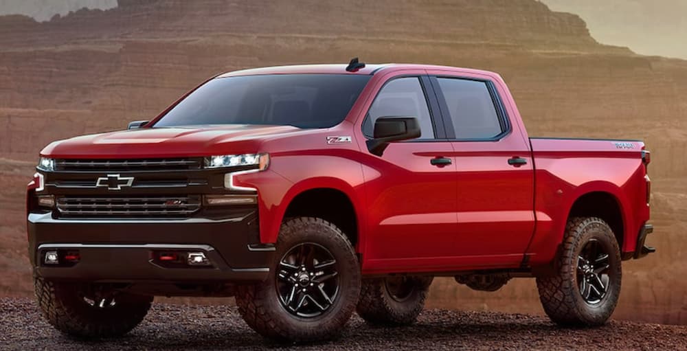 A red 2021 Chevy Silverado 1500 is parked in the desert after winning a 2021 Chevy Silverado 1500 vs 2021 Toyota Tundra comparison.
