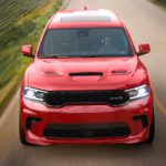 A red 2021 Dodge Durango is shown from the front driving down a two way road after winning a 2021 Dodge Durango vs 2021 Kia Sorento comparison.