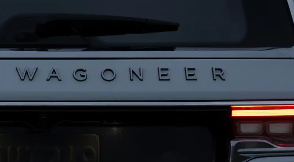 A close up of a white 2022 Wagoneer shows the Wagoneer emblem.